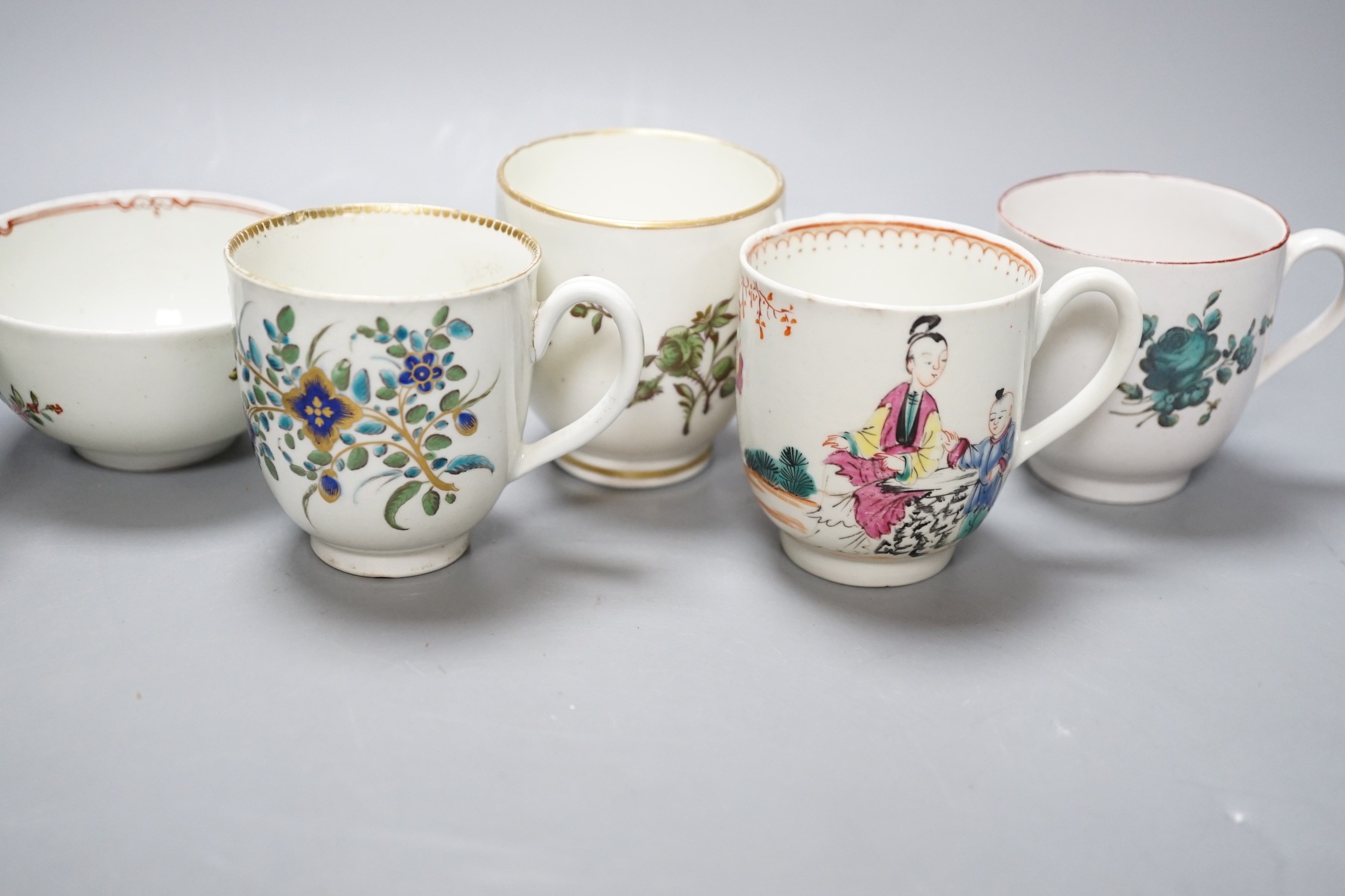 A Worcester coffee cup with oriental figures, another with flowers in green blue and gold, two Chelsea Derby coffee cups and two Christian Liverpool tea bowl with roses, largest bowl 9 cms diameter